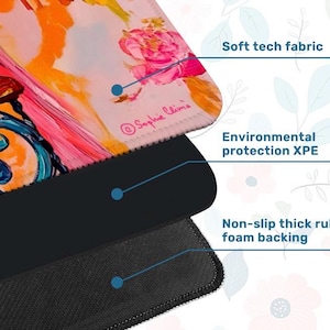 May include: A close-up of a mousepad with a floral design in pink, orange, and blue. The mousepad has a soft tech fabric surface, environmental protection XPE, and a non-slip thick rubber foam backing. The artist's signature, Sophie Clima, is visible.