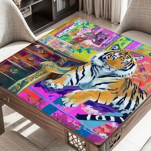 May include: A wooden coffee table with a colorful, artistic design. The tabletop features a vibrant painting of a tiger, surrounded by floral and geometric patterns in shades of pink, purple, and green. The table is surrounded by chairs.
