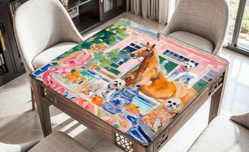 May include: A wooden coffee table with a colorful, artistic painting on the tabletop. The painting depicts a horse, small dogs, and a woman in a pink dress. The table is surrounded by chairs.