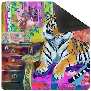 May include: A colorful mouse pad featuring a tiger resting on a pink chair. The tiger has orange and black stripes. The background includes a dresser, flowers, and a window with a tiger image. The artist's signature is in the bottom right corner.