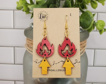 May include: A pair of wooden earrings with a red and yellow flame design. The earrings are hypoallergenic.