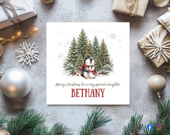 May include: A square greeting card featuring a watercolour illustration of two penguins wearing red scarves standing in front of decorated Christmas trees. The text reads Merry Christmas to a very special daughter BETHANY in black and red lettering.