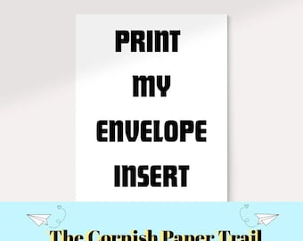 May include: A white card with the text "PRINT MY ENVELOPE INSERT" in bold black letters. Below the text is a light blue banner with the text "The Cornish Paper Trail" and paper airplane illustrations.