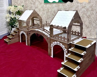 May include: A wooden pet habitat with a bridge, stairs, and two structures. The habitat is brown with white accents and a red base. The text "Color Options" is visible in the upper left corner.