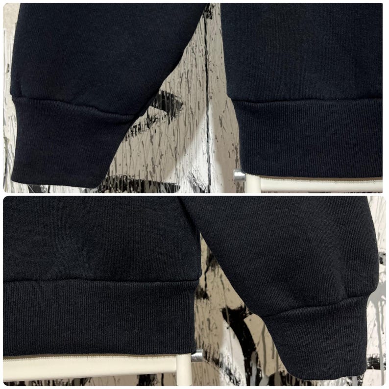 May include: Close-up of a black sweatshirt with ribbed cuffs and hem. The fabric appears to be a soft, medium-weight material. The image is a composite of four different views of the garment's sleeves and lower hem.
