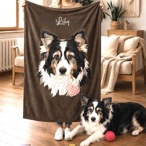 May include: A brown rectangular fleece blanket featuring a large embroidered portrait of a black, white, and tan dog. The name Lily is stitched in white script above the dog, and a small pink and white checkered heart is attached below.