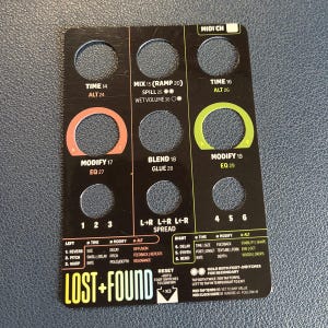 May include: A black rectangular overlay panel for a guitar effects pedal featuring circular cutouts, white, orange, and green text, and the label LOST+FOUND. The layout includes columns for TIME, MIX, BLEND, and MODIFY settings with numerical indicators.