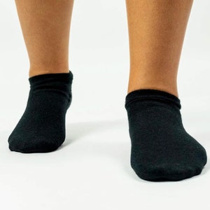 May include: A pair of black ankle socks. The socks are made of a soft, comfortable material and are perfect for everyday wear.