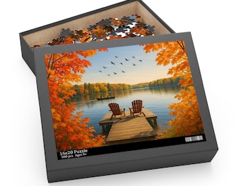 May include: A 16x20 inch puzzle box with a scenic image of a lake in autumn. The image shows a wooden dock with two chairs, surrounded by trees with orange leaves. The box contains 500 pieces and is for ages 9+.