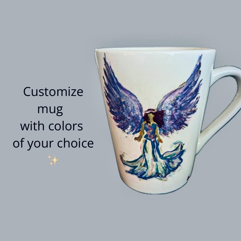 May include: White ceramic mug with a hand-painted design of an angel with purple wings and a flowing gown. The text "Customize mug with colors of your choice" is visible on the left side of the image.