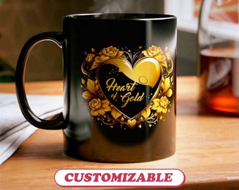May include: Black ceramic coffee mug with a gold heart design and the text "Heart of Gold".
