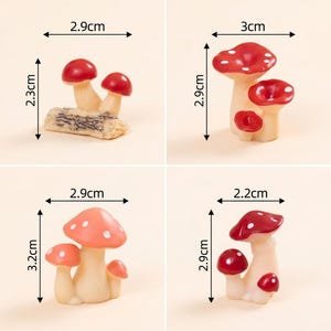 May include: Four miniature mushroom figurines with red and white caps and cream-colored stems. The first measures 2.9 cm by 2.3 cm, the second 3 cm by 2.9 cm, the third 2.9 cm by 3.2 cm, and the fourth 2.2 cm by 2.9 cm, as indicated by labels.