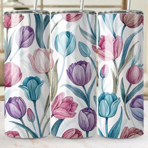 May include: Three stainless steel tumblers with a white background and a floral pattern of pink, purple, and blue tulips.