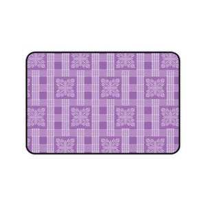 May include: Rectangular mousepad with a purple plaid pattern. The design features a grid of intersecting lines in varying shades of purple, with floral-like motifs at the intersections. The mousepad has a black border.