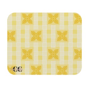 May include: A yellow and white plaid pattern with floral accents on a rounded square surface. The design features a grid of white lines over a yellow background, with stylized floral motifs. The text "Cai Crafts" is in the lower left corner.