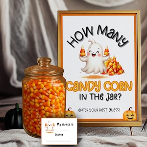 May include: A Halloween-themed display featuring a glass jar filled with candy corn, a sign that reads "How Many Candy Corn in the Jar?", and a small card for guesses. A cute ghost graphic is on the sign.