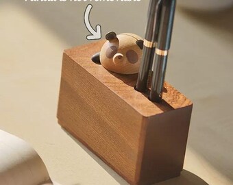 May include: A wooden pen holder with a small panda figurine on top. The panda is not removable. The holder has three slots for pens.