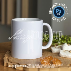 May include: White ceramic mug mockup on a wooden surface with candy and white sweets. The mug is 11 ounces and has a handle. The text "Mug mockup" is written in white on the mug.