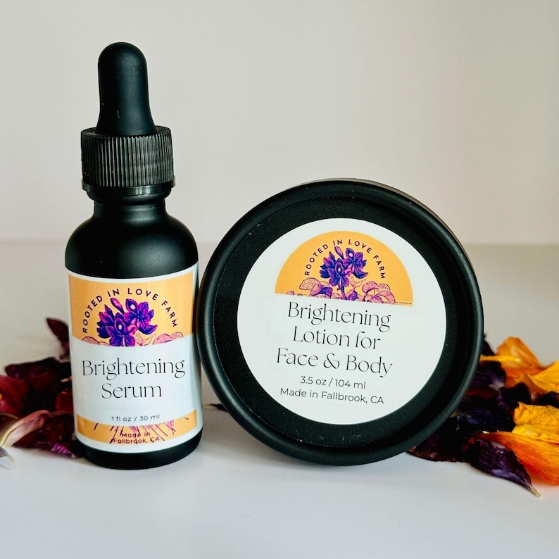May include: A black dropper bottle of Brightening Serum and a black jar of Brightening Lotion for Face & Body. The serum bottle is 1 fl oz / 30 ml. The lotion jar is 3.5 oz / 104 ml. Both have labels with floral designs.