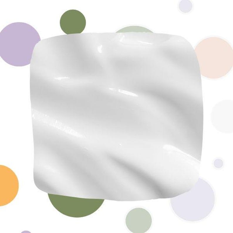 May include: A square, white, glossy object with a rippled surface. The object is set against a white background with colorful, circular shapes in shades of green, purple, and orange.