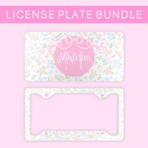 May include: A white license plate frame with a floral pattern and a pink circle with the name "Madison" in a cursive font. The frame is designed to fit a standard US license plate.