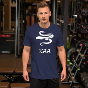 May include: A navy blue t-shirt with a white graphic of a snake and the word "KAA" printed on the front.