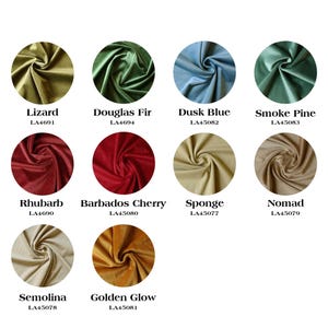 May include: A collection of 10 fabric swatches in various colors and textures, including green, blue, red, beige, and yellow. Each swatch is labeled with a name and a code, such as "Lizard LA4691" and "Golden Glow LA45081".