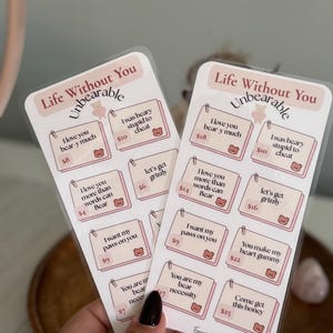 May include: Two sticker sheets with bear-themed puns and the text "Life Without You Unbearable". Each sticker has a price tag. The stickers are on a clear backing.