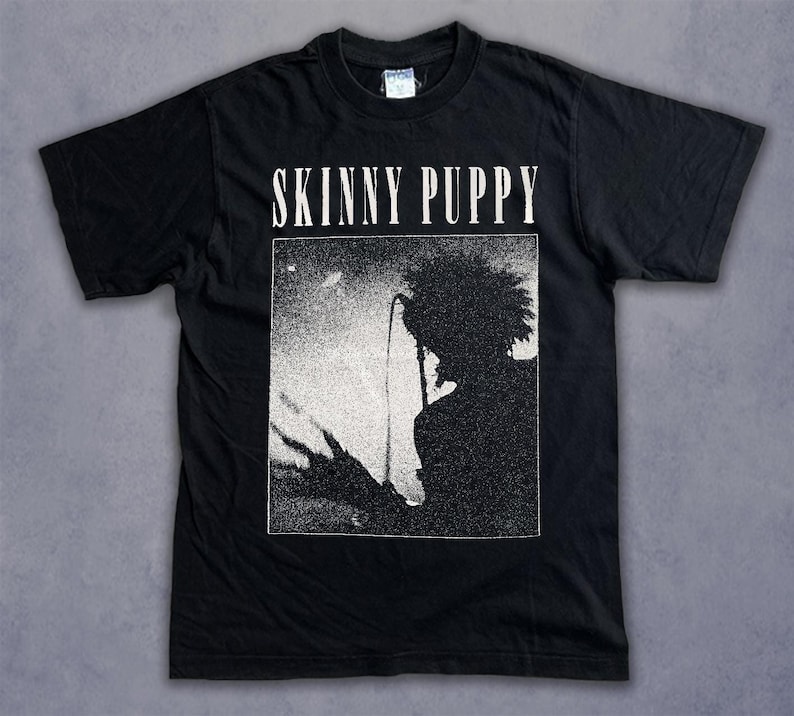 a black shirt with a picture of a man holding a surfboard