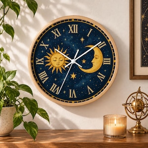 May include: A round wall clock with a light wood frame featuring a dark blue celestial face. The dial displays a golden sun and crescent moon with closed eyes, surrounded by yellow stars and white Roman numerals. Three white clock hands are centered.