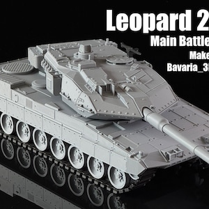 May include: A grey Leopard 2 A7 Main Battle Tank model. The model features a long gun barrel, detailed tracks, and the text "Leopard 2 A7", "Main Battle Tank", "MakerWorld", and "Bavaria_3D Tanks" in white.