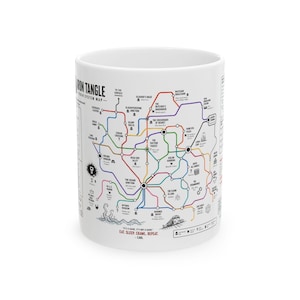 May include: White ceramic mug featuring a colorful map design with various locations and text. The mug includes the text "EAT, SLEEP, CRAWL, REPEAT - CARL". The map design is a network of lines and symbols.