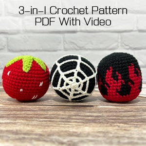 May include: Three spherical crochet items featuring a 3-in-1 Crochet Pattern PDF With Video. The first is a red strawberry with green leaves, the second is a black sphere with a white spiderweb, and the third is a black sphere with red flames.