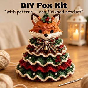 May include: A DIY Fox Kit with pattern, non finished product. The crochet fox head sits atop a tiered, ruffled Christmas tree base in green and red, decorated with white pearls, red berries, a plaid bow, and a small gold bell.