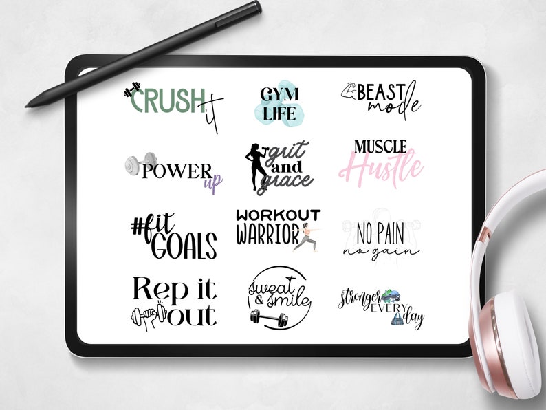 May include: A digital tablet screen displaying a collection of motivational fitness quotes and graphics. The quotes include "Crush It", "Gym Life", "Beast Mode", "Power Up", "Grit and Grace", "Muscle Hustle", "#Fit Goals", "Workout Warrior", "No Pain No Gain", "Rep It Out", "Sweat and Smile", and "Stronger Every Day".