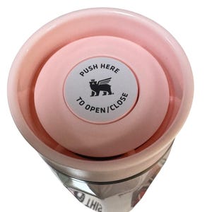 Peut inclure: Un gobelet isotherme rose avec un couvercle assorti. Le couvercle comporte un bouton circulaire avec le texte "PUSH HERE TO OPEN/CLOSE" et un dessin d'animal ail&eacute;. Le gobelet est con&ccedil;u pour garder les boissons chaudes ou froides.