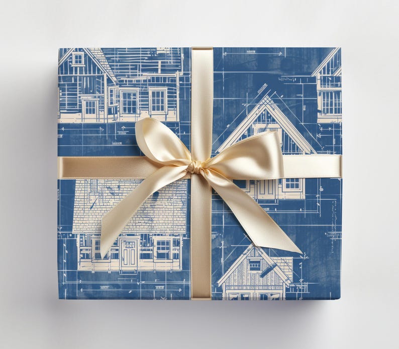 May include: Blue and white wrapping paper with a blueprint design of houses. The paper is tied with a gold ribbon and bow.
