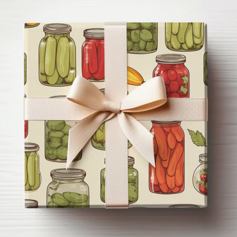 May include: A gift box wrapped in cream paper with a beige ribbon. The paper features a repeating pattern of various jars filled with pickled vegetables, peppers, and tomatoes.