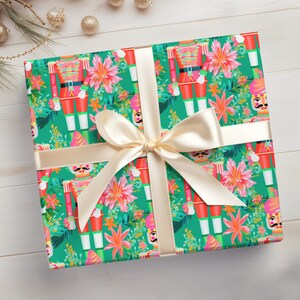 May include: Green gift wrap with a repeating pattern of colourful nutcracker soldiers and pink flowers. The gift wrap is tied with a cream-coloured ribbon.