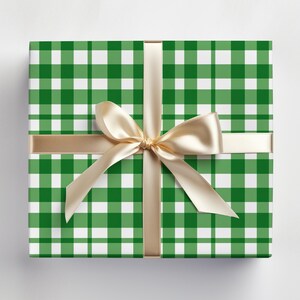 May include: A green and white gingham gift box with a gold ribbon tied in a bow.