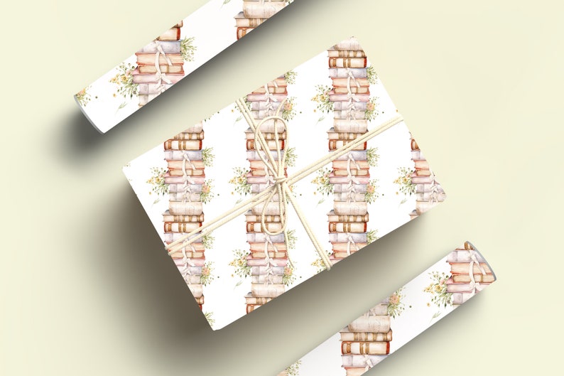 May include: White gift wrap with a repeating pattern of stacks of vintage books tied with twine and small sprigs of flowers.