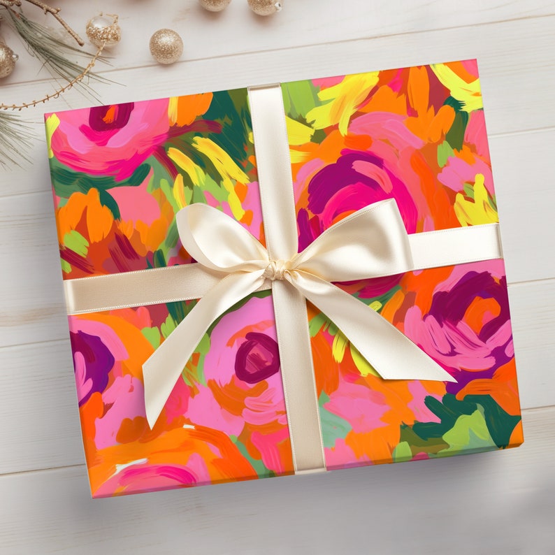 May include: A gift box wrapped in colorful floral patterned wrapping paper with a cream-colored satin ribbon tied in a bow.