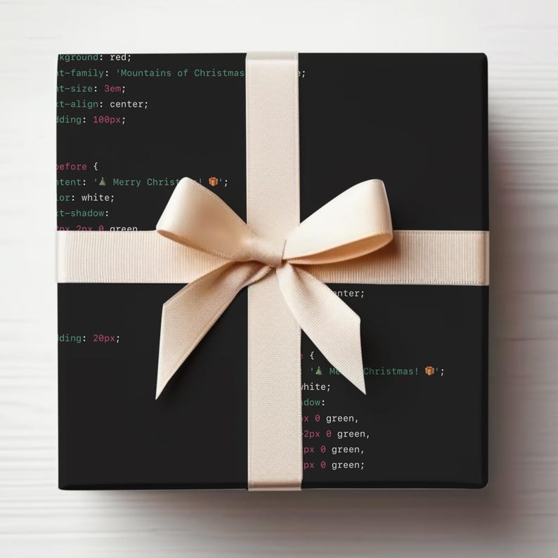 May include: A black gift box with a beige ribbon and bow. The box is wrapped in black paper with white text that reads: "background: red; t-family: 'Mountains of Christmas'; t-size: 3em; t-align: center; padding: 100px; before { content: 'Merry Christmas!'; color: white; t-shadow: 2px 0 green; } enter; padding: 20px; { white; dow: 2px 0 green, 2px 0 green, px 0 green, px 0 green; "