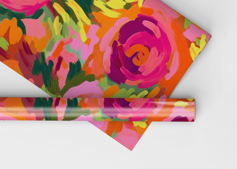 May include: A roll of colorful wrapping paper with a floral pattern. The paper features a bright pink, orange, yellow, and green abstract floral design.