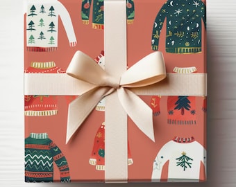 May include: A gift box wrapped in red paper with a white ribbon. The paper features a repeating pattern of colorful sweaters with holiday-themed designs.