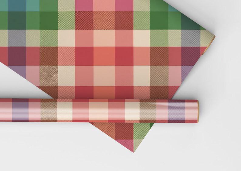 May include: A roll of colorful plaid wrapping paper with a variety of colors including red, green, and beige. The paper is unrolled to reveal the plaid pattern. A smaller roll of the same paper is also visible.