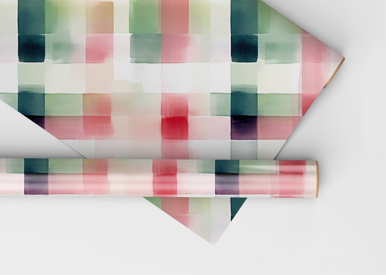 May include: Two rolls of wrapping paper with a watercolor plaid pattern in shades of pink, green, and white.