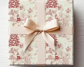 May include: A square gift box wrapped in cream-colored paper with a red toile pattern of winter scenes, including trees and houses. A cream-colored ribbon is tied in a bow around the box, creating a festive and elegant presentation.