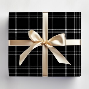May include: A black and white plaid gift box with a gold satin ribbon tied in a bow.