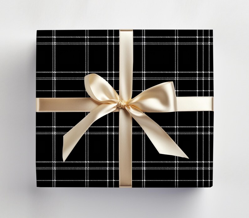 May include: A black and white plaid gift box with a gold satin ribbon tied in a bow.